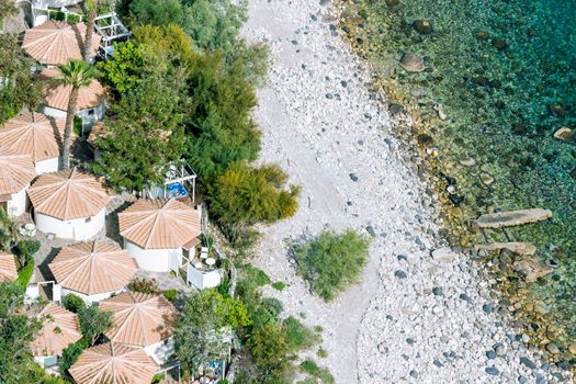 Aeral view of sicilian beach with peopAeral view of sicilian beach with people, umbrellas and wonderful sea.