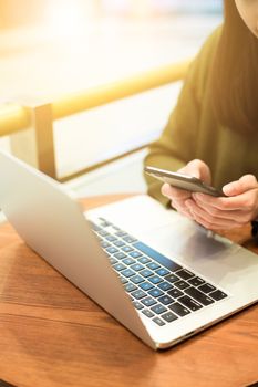 Woman use of mobile phone and laptop computer