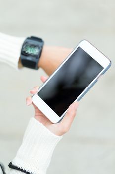 Woman use of smartwatch and cellphone