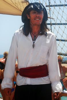 Man Wearing Pirate Costume with Ship Background