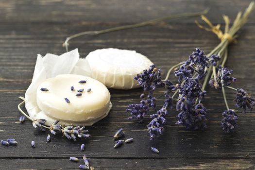 Closeup of natural herbal soap with lavender flower on a dark wooden background