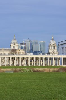 LONDON, UK - DECEMBER 28: Heavily built cityscape with National Maritime museum in the foreground and Canary Wharf skyscrapers in the background. December 28, 2015 in London.