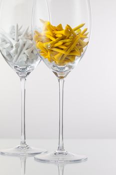 Two glasses of wine and golf equipments on the white background