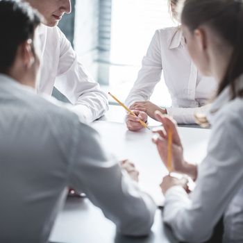 Group of business people working together at meeting in office