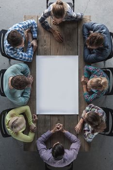 Hipster business teamwork brainstorming planning meeting concept, people sitting around the table with white paper