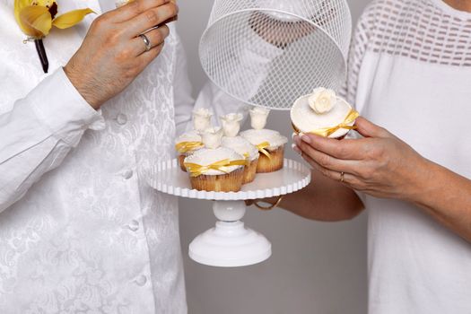 Beautiful wedding cakes in the hands of a pair