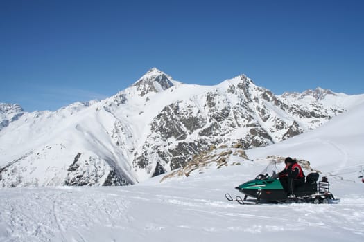 Snowmobile in the mountains of Dombai, Caucasus