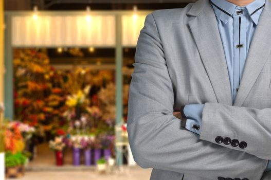 Businessman as Florist standing in front of Flower or Floral Shop, Small business owner or Entrepreneur Concept