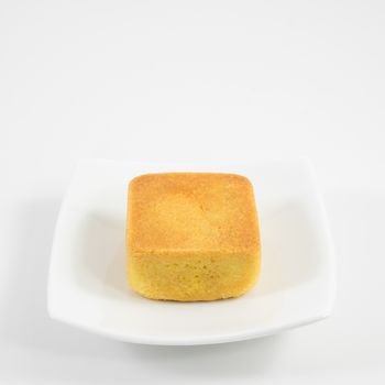 The tasty Taiwanese pineapple pastry cake on the small white square dish.