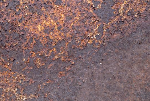 rusty iron surface covered with old chipped paint, which has long been influenced by different climatic conditions