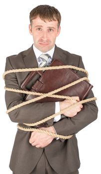 Young sad businessman and briefcase tied with ropes