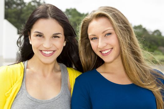 Two happy and beautiful teenage students in the school 