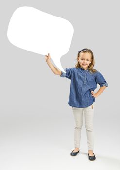 Beautiful little girl holding and showing a speech balloon