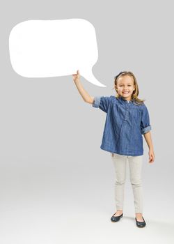 Beautiful little girl holding and showing a speech balloon