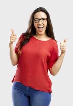 Beautiful and happy woman with thumbs up, isolated over white background 