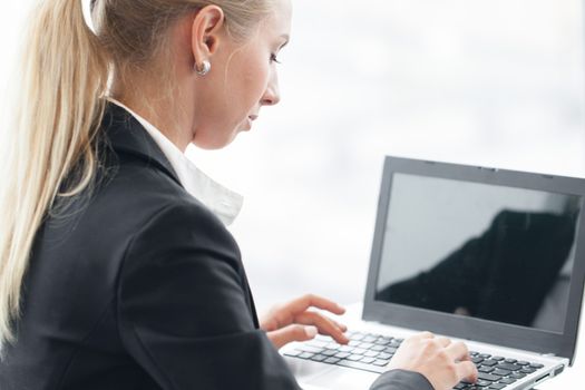 Business woman working with laptop close up view