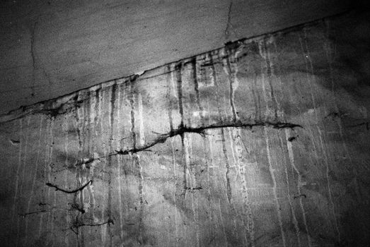 Black and white image of cracks in concrete wall