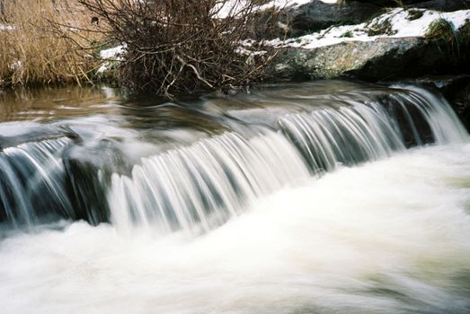 Color film image of small waterfall in Aviemore