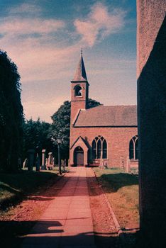Color film image of church and cemetery in Laurencekirk