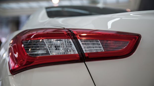 Detail on the rear light of a white car