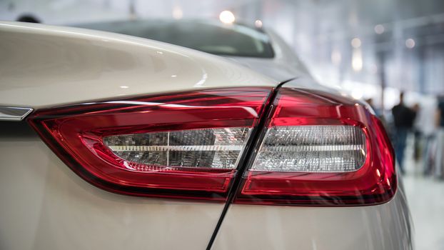 Detail on the rear light of a white car