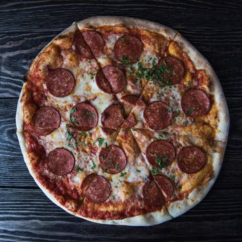 Pepperoni pizza on wooden table