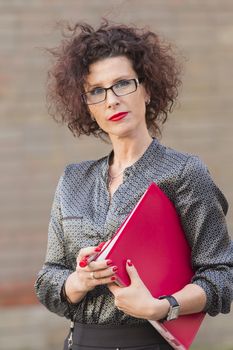 business woman in glasses with a folder in his hand