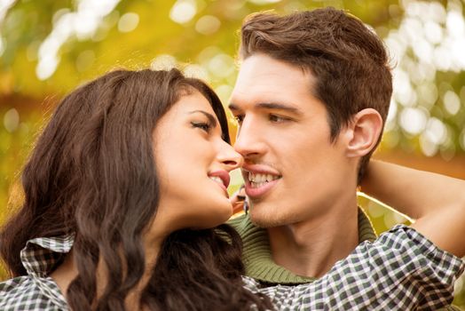 Close-up of a young heterosexual couple in love at the moment before or after the kiss.