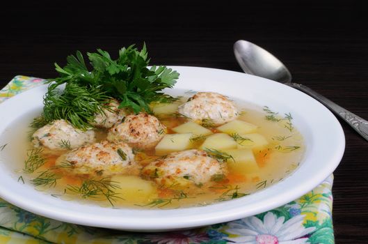 chicken broth of potatoes, carrots and meatballs sprinkled with dill