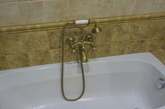 bathroom with shower and faucet made of brass in retro style