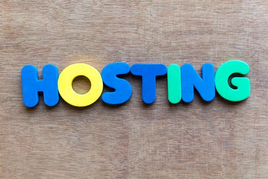 hosting colorful word in the wooden background