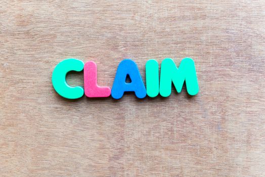 claim colorful word in the wooden background