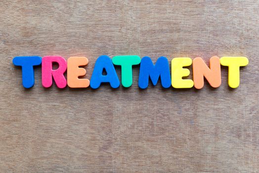 treatment colorful word in the wooden background