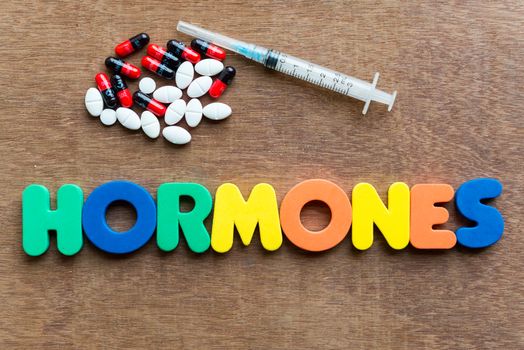 hormones colorful word in the wooden background