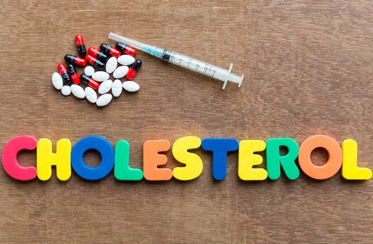 cholesterol colorful word in the wooden background