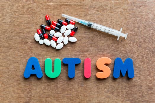 autism colorful word in the wooden background