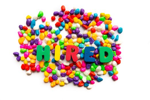 hired word in colorful stones