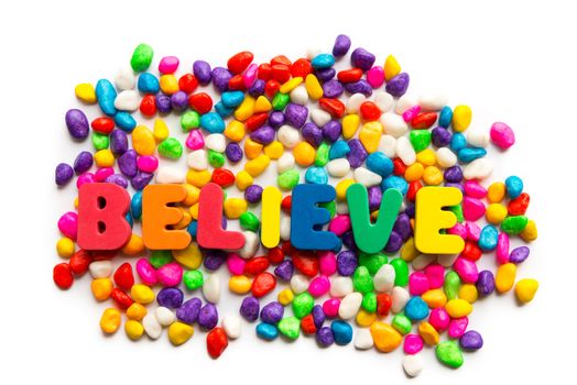 believe word in colorful stones