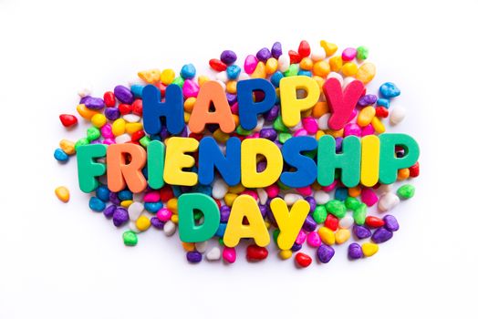 happy friendship day word in colorful stones