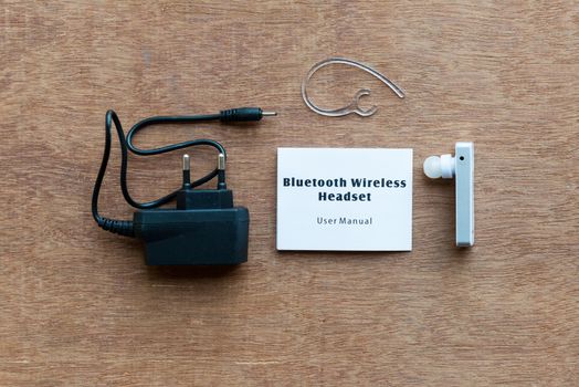 bluetooth device with charger on wooden background