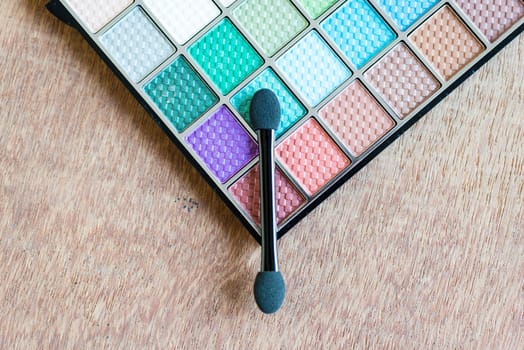 colorful Eyeshadow palette on the wooden background