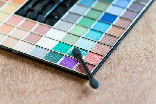 colorful Eyeshadow palette on the wooden background