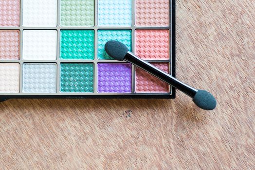 colorful Eyeshadow palette on the wooden background