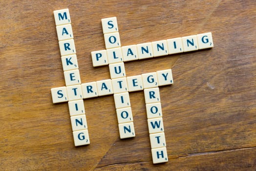 marketing strategy crossword blocks on the wooden background