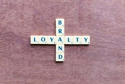 brand and loyalty crossword blocks on the wooden background