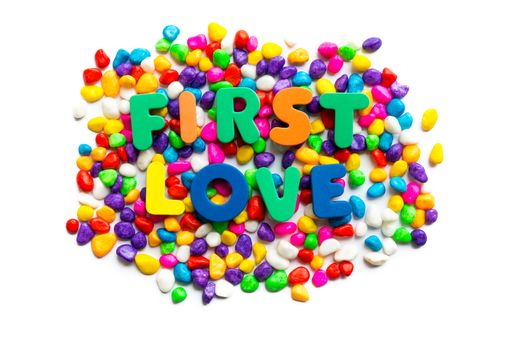 first love words on the colorful stone and white background