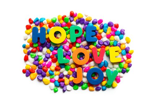 hope love joy words on the colorful stone and white background