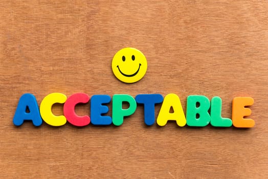 Acceptable colorful word on the wooden background