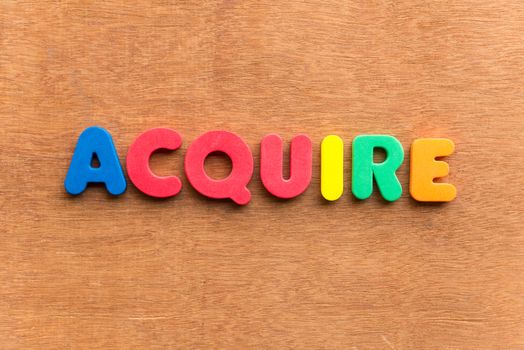 acquire colorful word on the wooden background