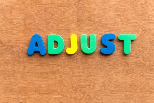 adjust colorful word on the wooden background